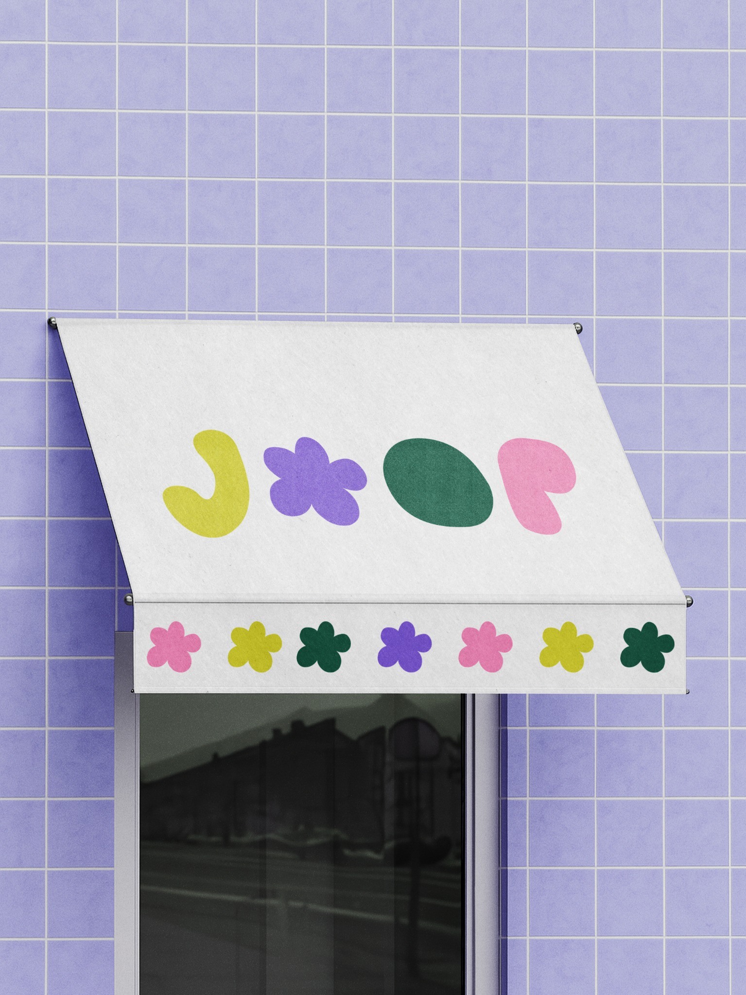 White JOOP awning with colourful motifs against a lilac tiled facade