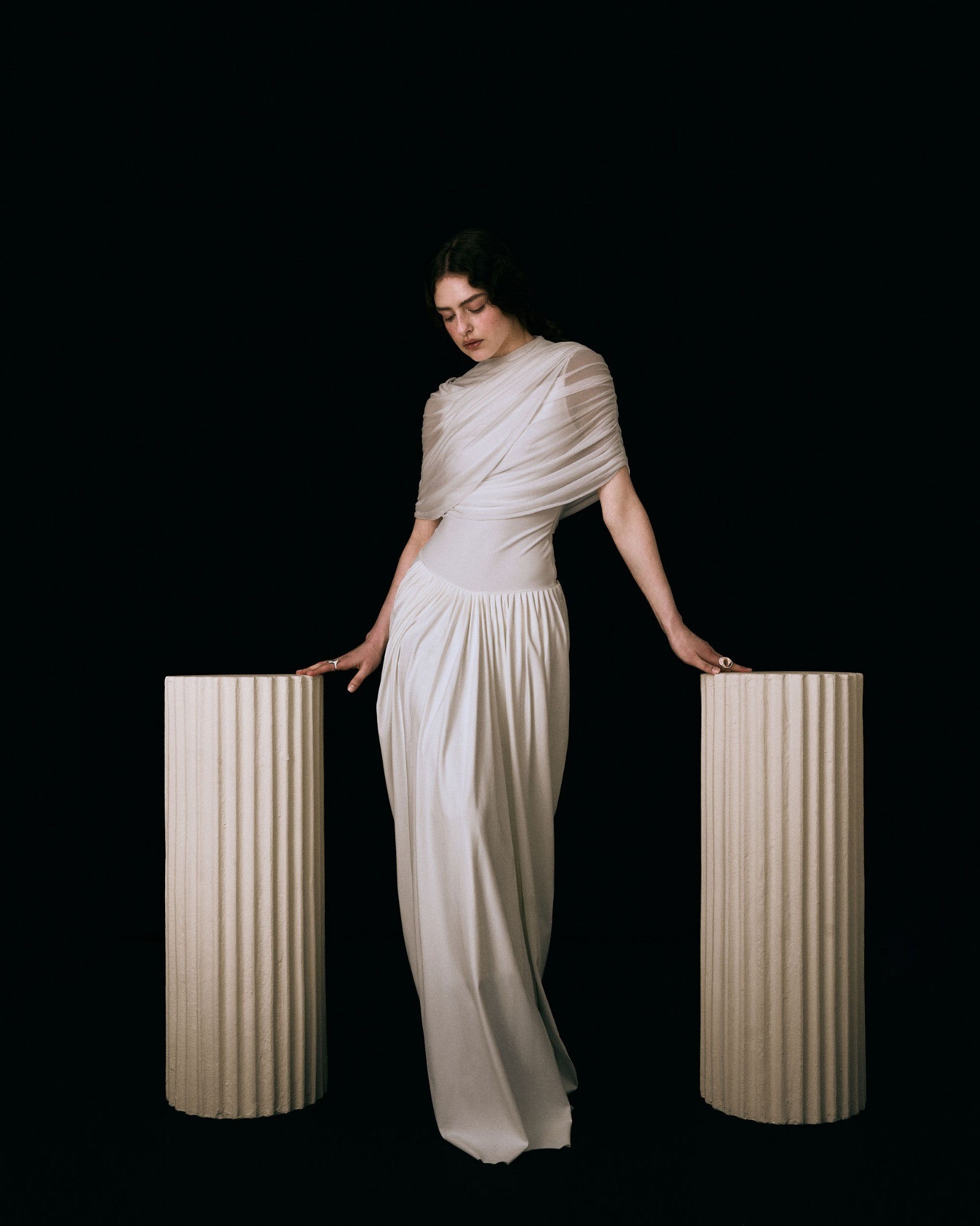 Full-length campaign portrait between two fluted columns