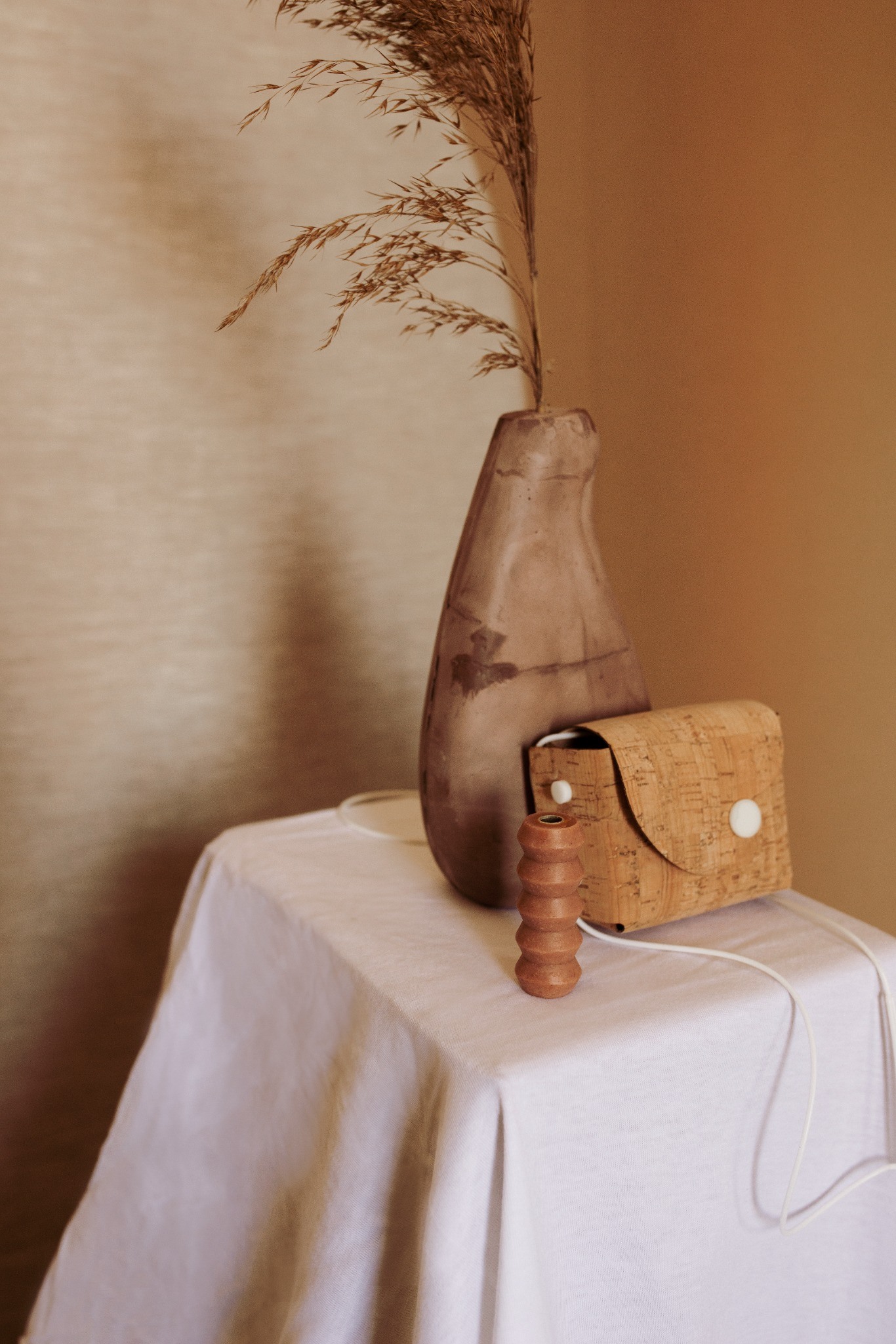Soap and cork packaging arranged on a draped table