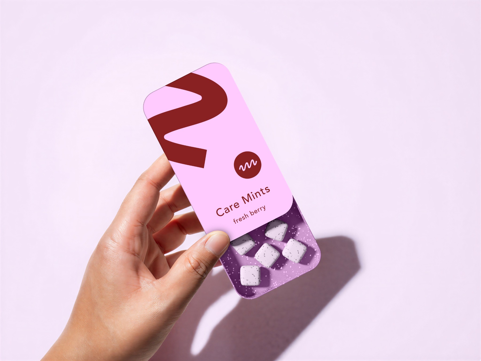Pink Care Mints case held in a hand
