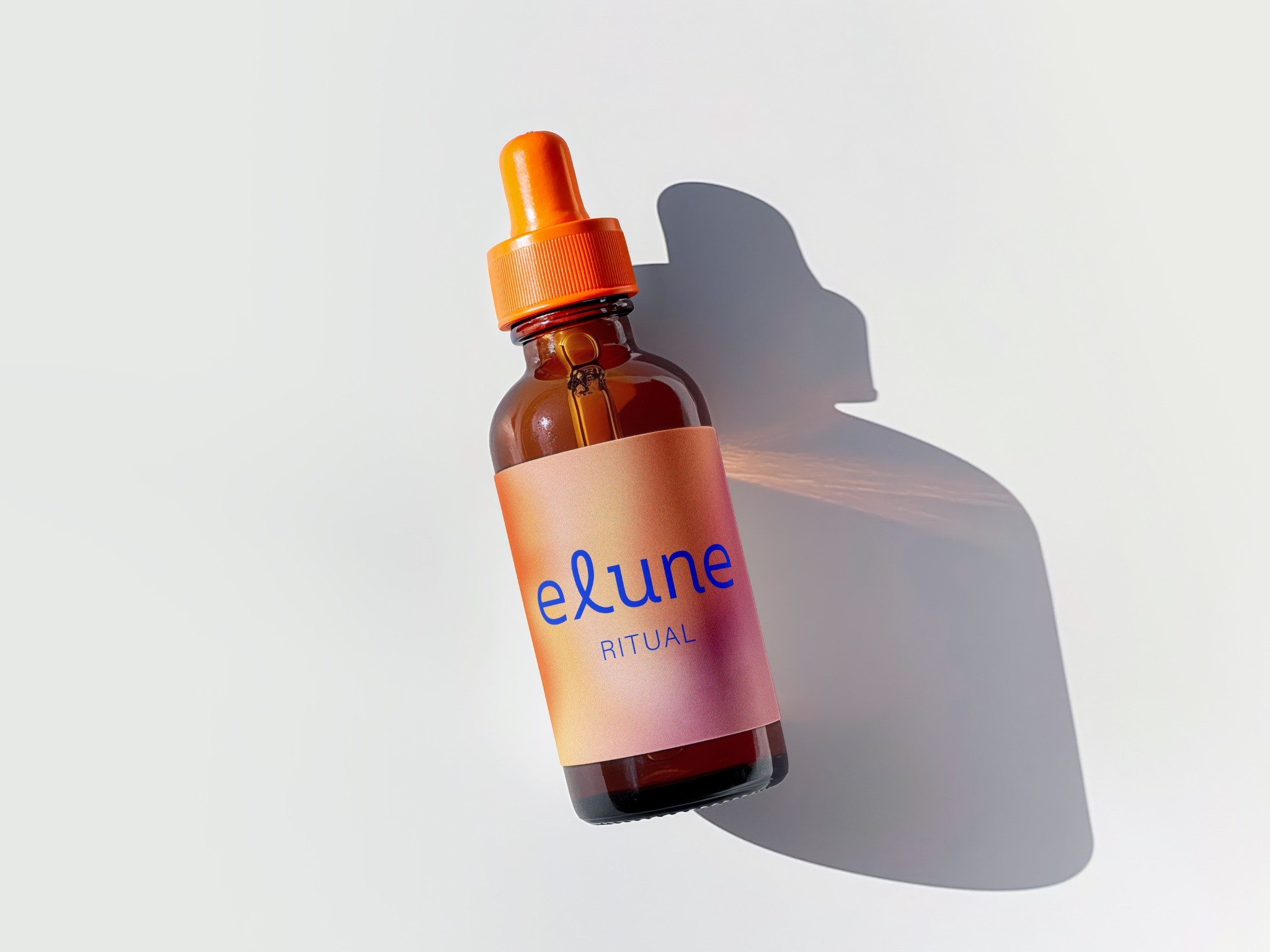Elune Ritual dropper bottle with an orange cap