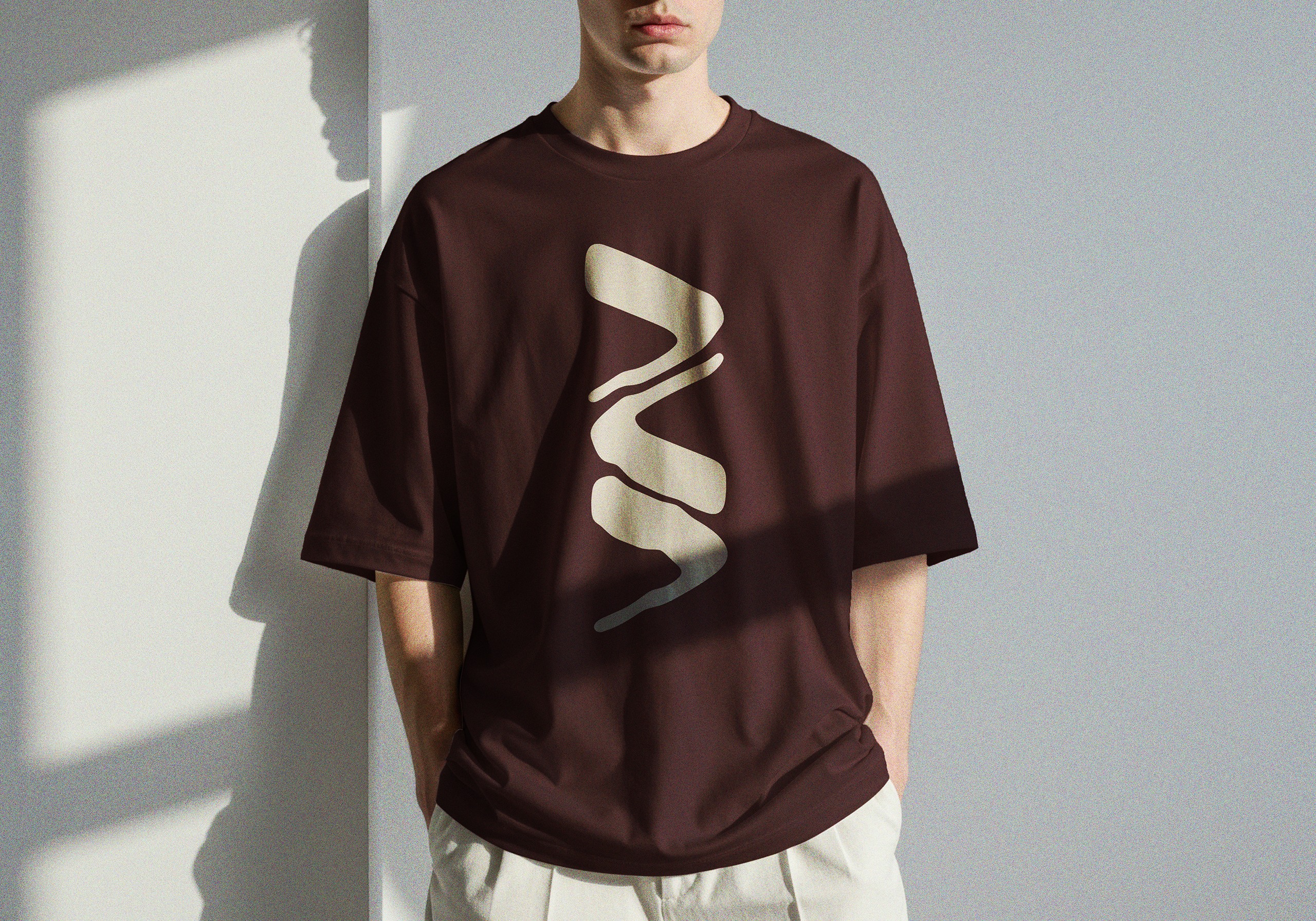 Cream fluid graphic on a burgundy T-shirt